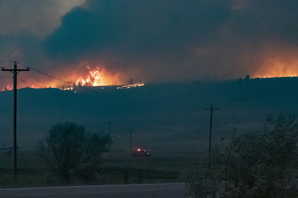 The Elmo Fire burns near high voltage power transmission lines west of Flathead Lake near Elmo on Friday, July 29, 2022. (Rob Zolman/Lake County Leader)