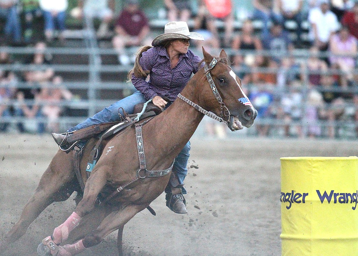Barrel racer Heidi Schmid of Kalispell turns in a time of 17.73 Friday evening at the Kootenai River Stampede. (Paul Sievers/The Western News)