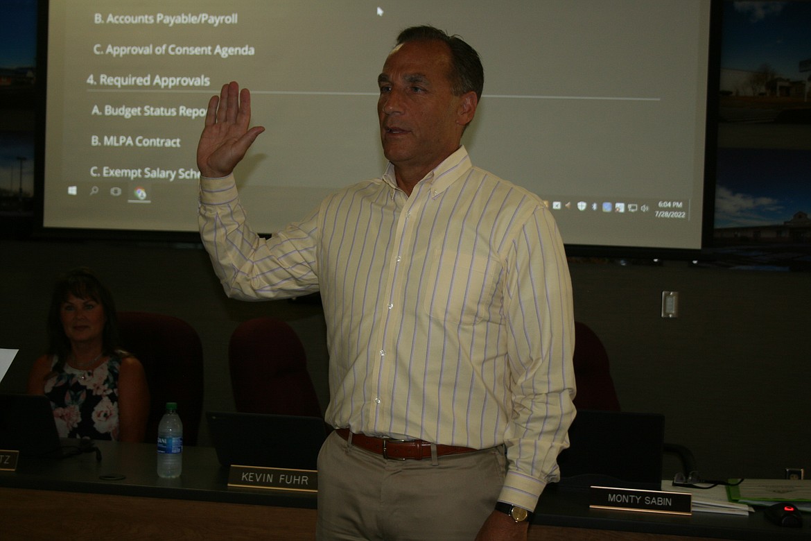 Moses Lake School Superintendent Monty Sabin takes the oath of office during the Moses Lake School Board meeting Thursday. Sabin was selected by the school board after a thorough search for candidates to fill the role.