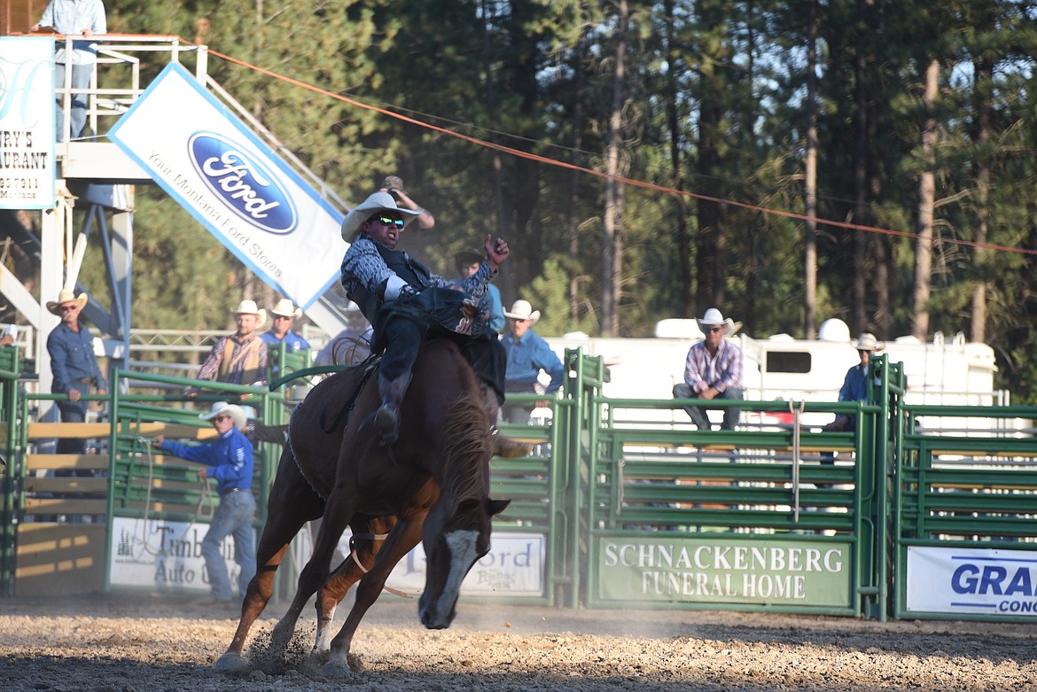 Tucker Zingg, of Crow Agency, works to hang on during the bareback riding event Saturday night at the Kootenai River Stampede. (Scott Shindledecker/The Western News)