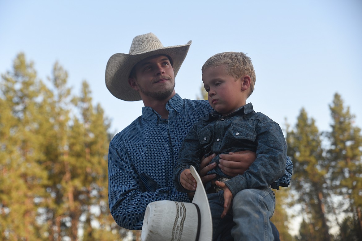 Libby cowboys Kris Ledbetter and Cashton Morrison take a short break Saturday night at the Kootenai River Stampede. (Scott Shindledecker/The Western News)