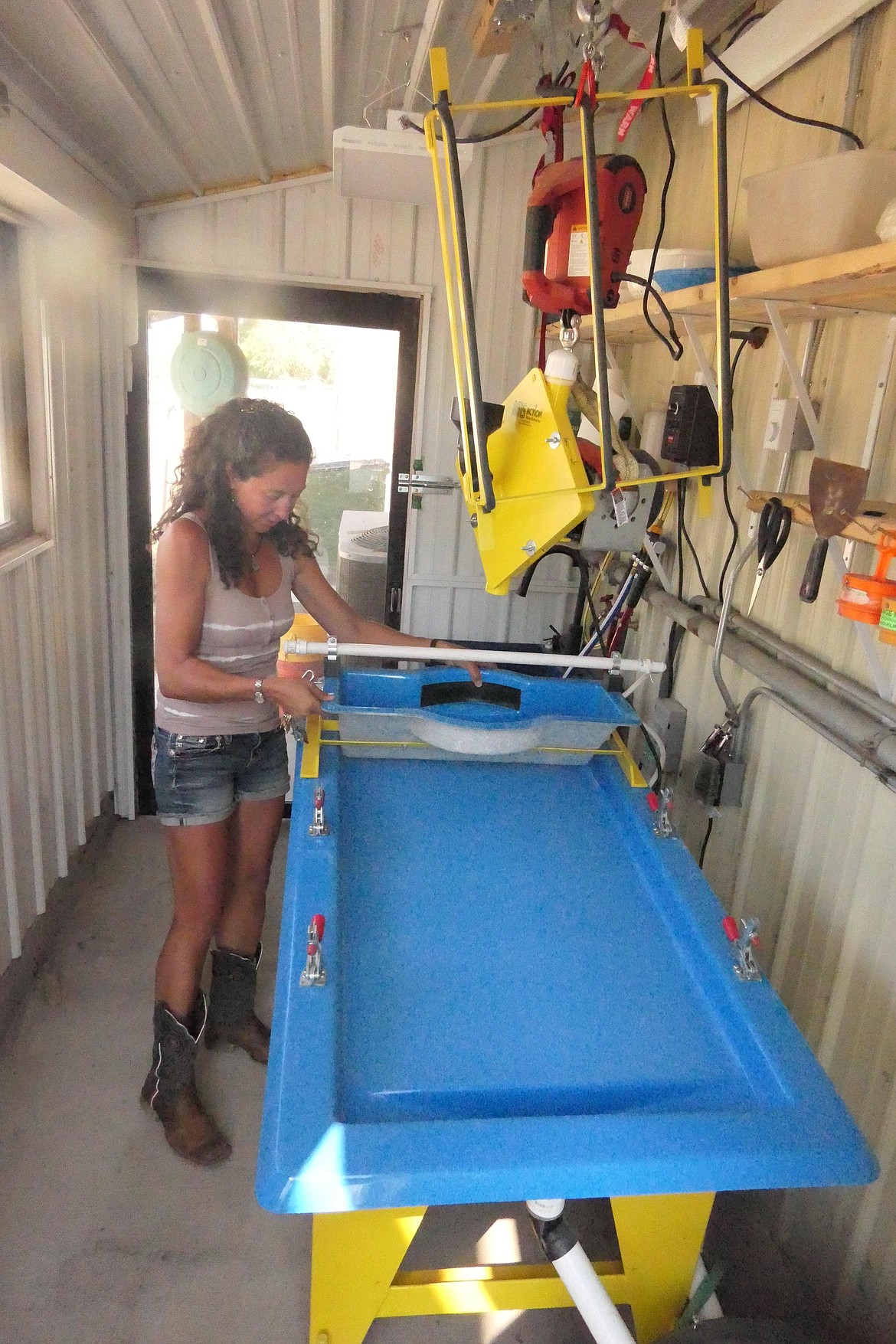 Action Mining Services co-owner Jessica Pullen shows a "shaker table" used in mineral separation. Such equipment and other mining related gear can be purchased at the store in Plains. (Chuck Bandel/VP-MI)