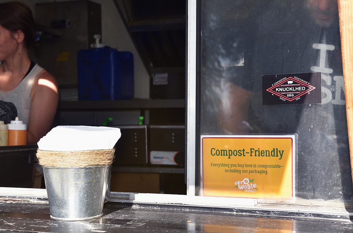 Signage at every food truck lets customers know that all the packaging at the market, a Zero Waste Event, is compostable, including the dishes. (Julie Engler/Whitefish Pilot)