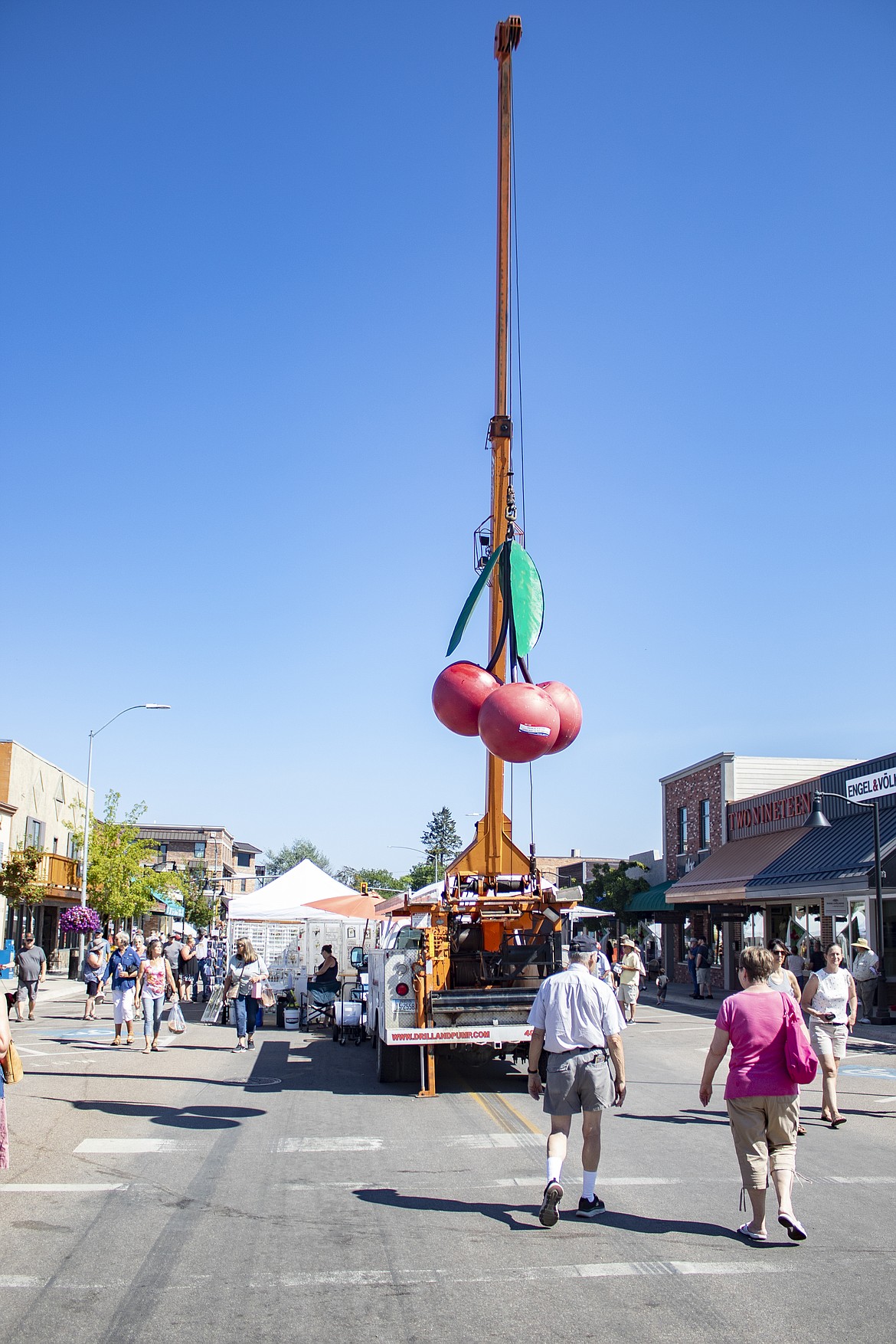 Cherries hang from a crane in downtown Polson during the Flathead Cherry Festival on Saturday. (Rob Zolman/Lake County Leader)