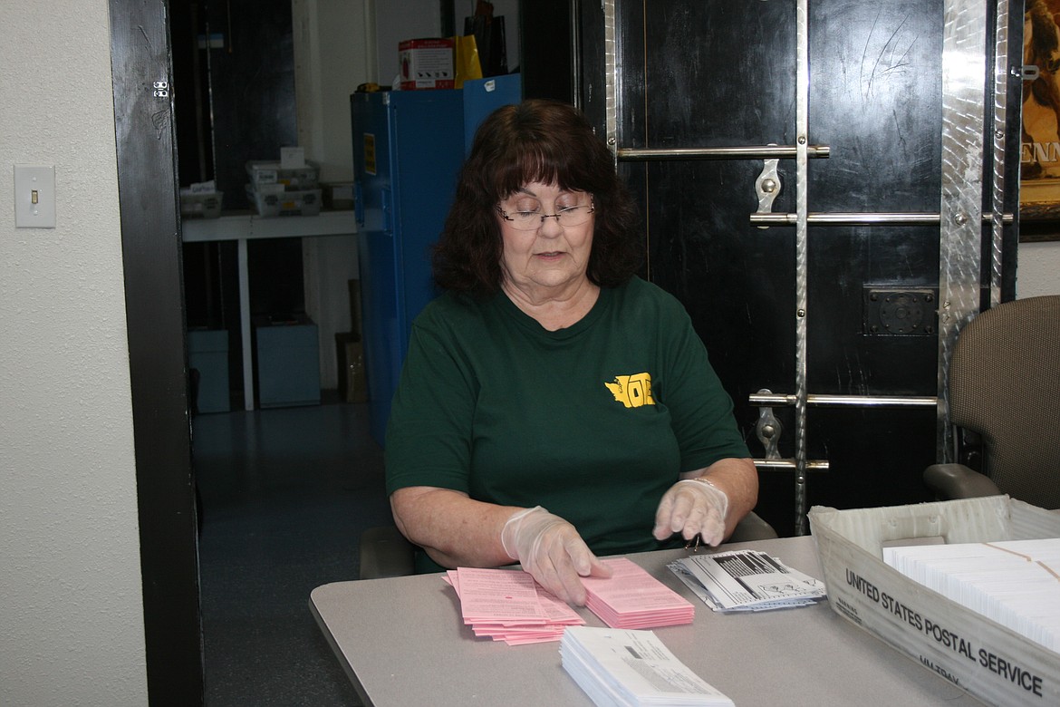 Dedra Osborn of the Grant County Auditor’s Office separates ballots from envelopes Tuesday.