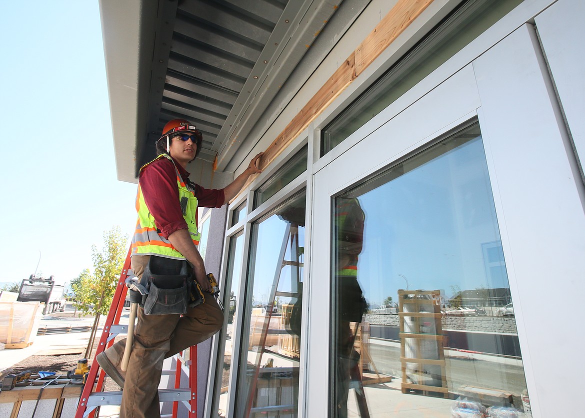 Matt Baca, general foreman for Engineered Structures, Inc., works on the front entrance of the new Elevate Academy North on July 19. The school will welcome its first students Aug. 23.