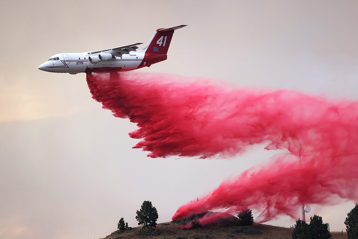 A Neptune Aviation tanker drops retardant to combat the spread of the Elmo Fire near Chief Cliff Monday afternoon, Aug. 1. (Jeremy Weber/Daily Inter Lake)