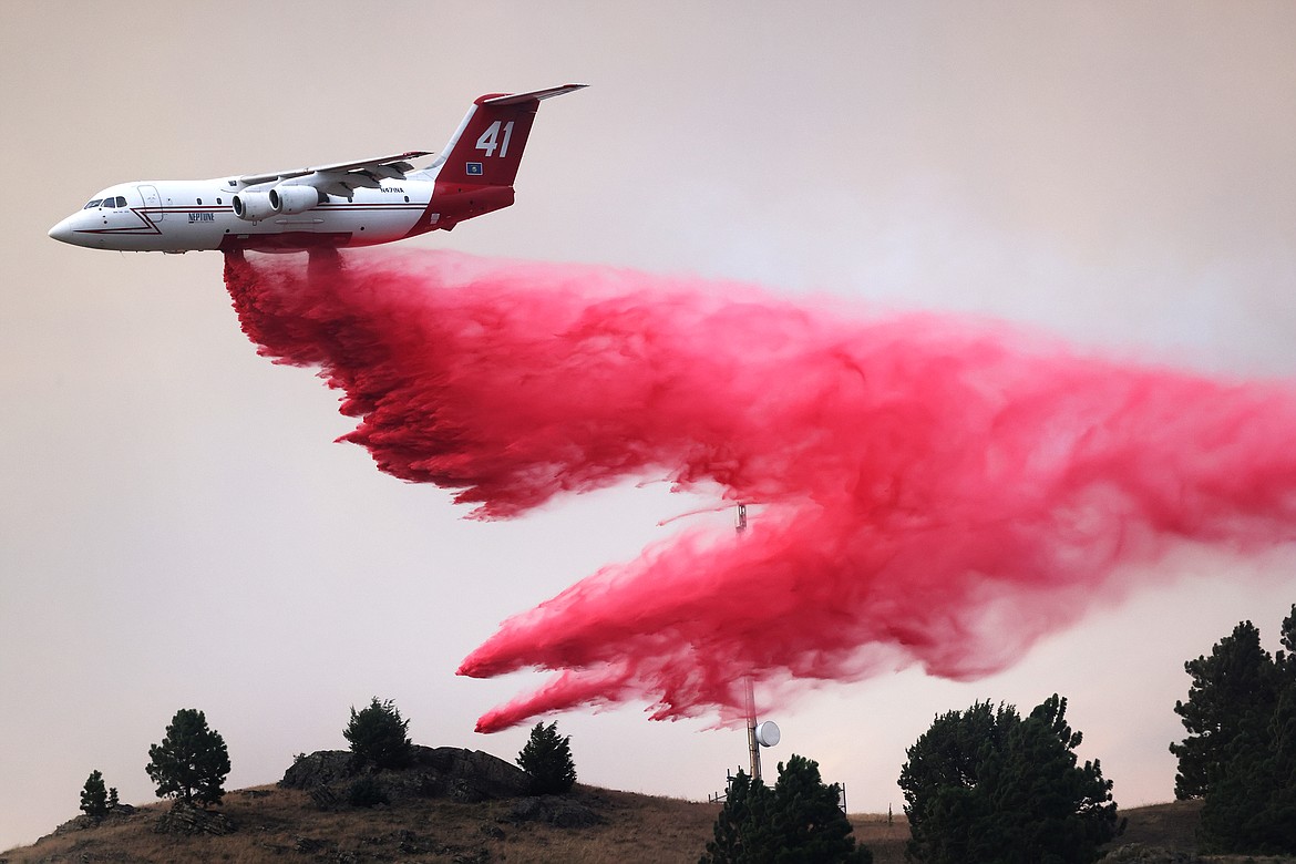 A Neptune Aviation tanker drops retardant to combat the spread of the Elmo Fire near Chief Cliff Monday afternoon, Aug. 1. (Jeremy Weber/Daily Inter Lake)