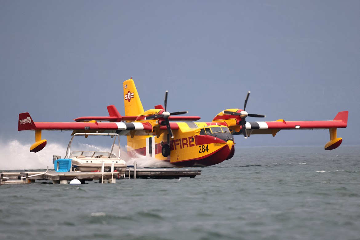 A Bridger Aerospace CL-415EAF super scooper pulls water out of Flathead Lake to fight the Elmo Fire near Chief Cliff Monday afternoon, Aug. 1. (Jeremy Weber/Daily Inter Lake)