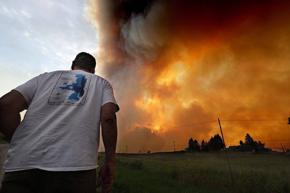 Dayton homeowner RJ Brewer keeps an eye on the Elmo fire as it approaches the community Monday afternoon, Aug. 1. (Jeremy Weber/Daily Inter Lake)