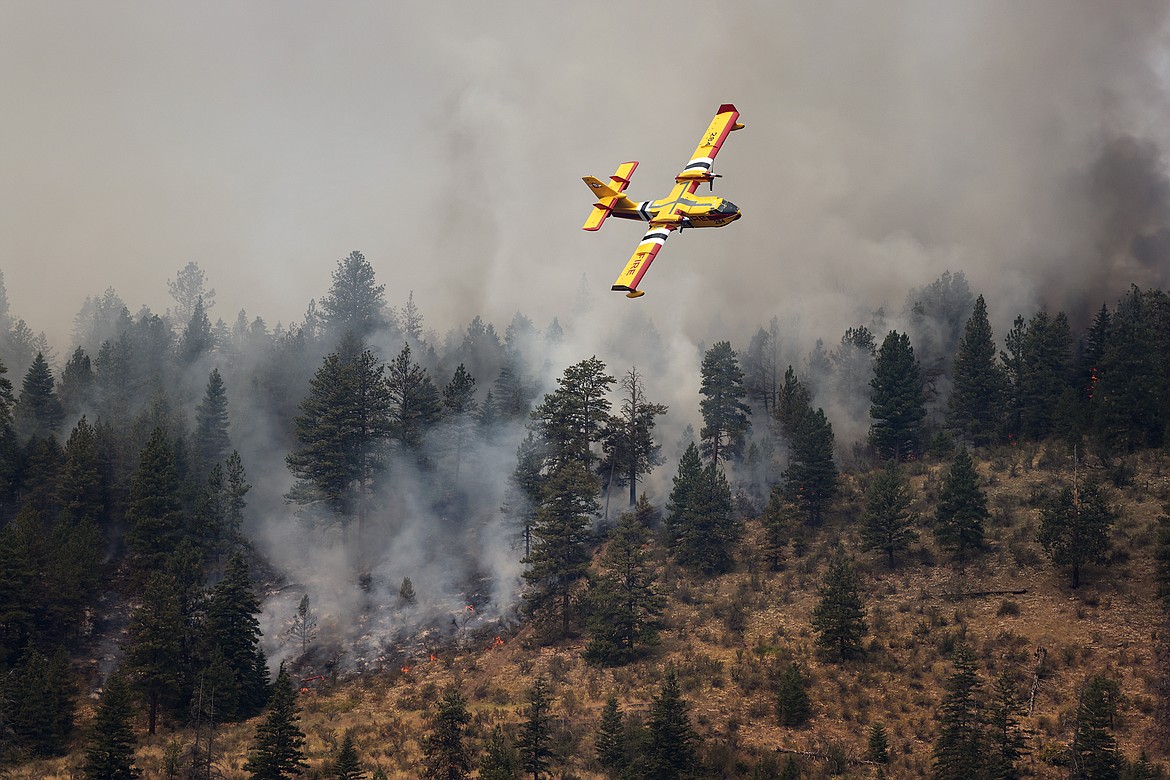A Bridger Aerospace CL-415EAF super scooper maneuvers over the Elmo Fire after dropping water near Black Lake Monday, Aug. 1. (Jeremy Weber/Daily Inter Lake)