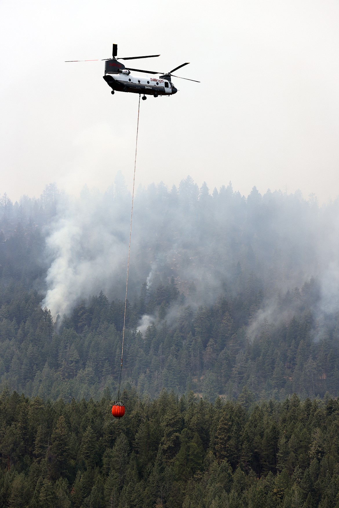 A Billings Flying Service CH-47D helicopter carries water from Black Lake to combat the Elmo Fire Monday, Aug. 1. (Jeremy Weber/Daily Inter Lake)