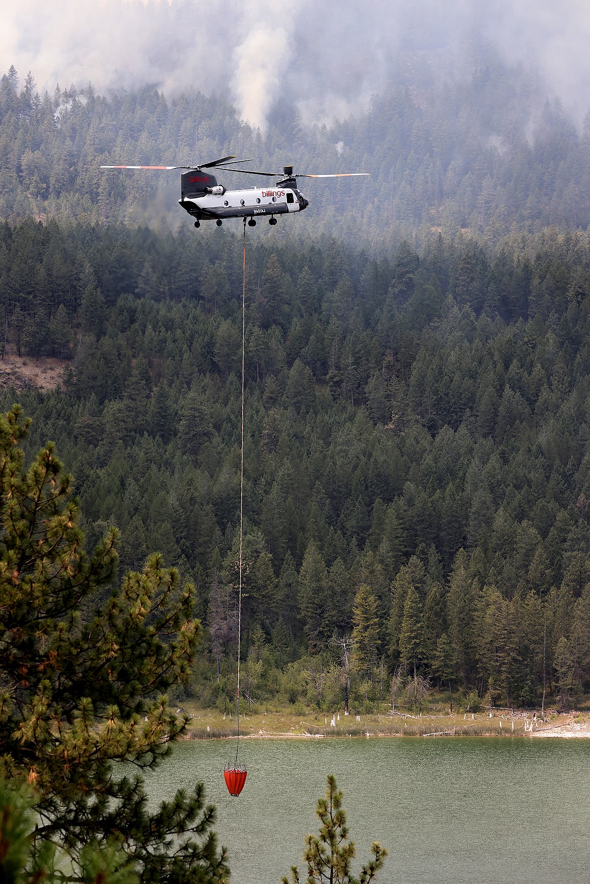 A Billings Flying Service CH-47D helicopter carries water from Black Lake to combat the Elmo Fire Monday, Aug. 1. (Jeremy Weber/Daily Inter Lake)