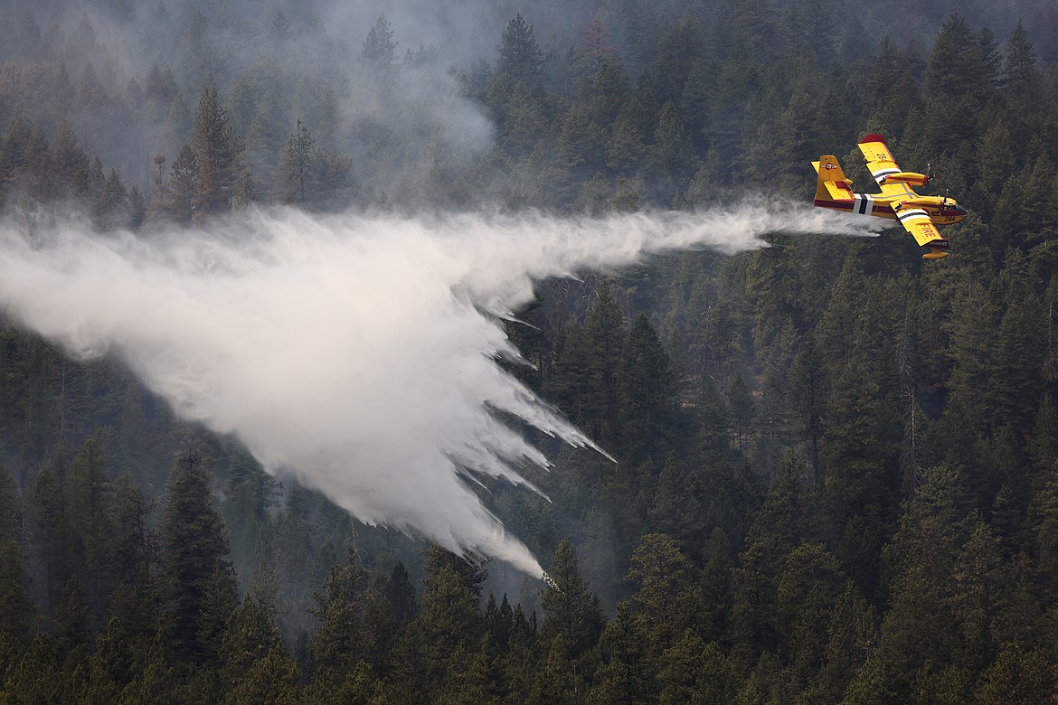 A Bridger Aerospace CL-415EAF super scooper drops water on the Elmo Fire near Black Lake Monday, Aug. 1. (Jeremy Weber/Daily Inter Lake)