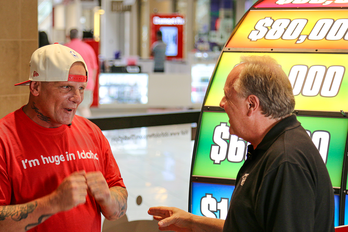 Lonnie Dahl of Priest River shows his excitement as he talks to Idaho Lottery's David Workman after winning $75,000 in the Big Spin game.