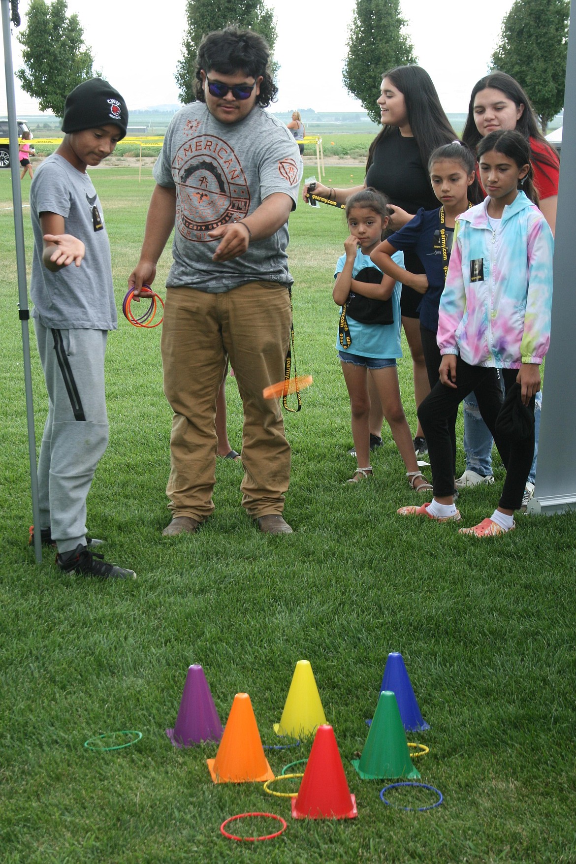 Jonathan Hernandez tries to beat the ring toss game at National Night Out in Quincy.