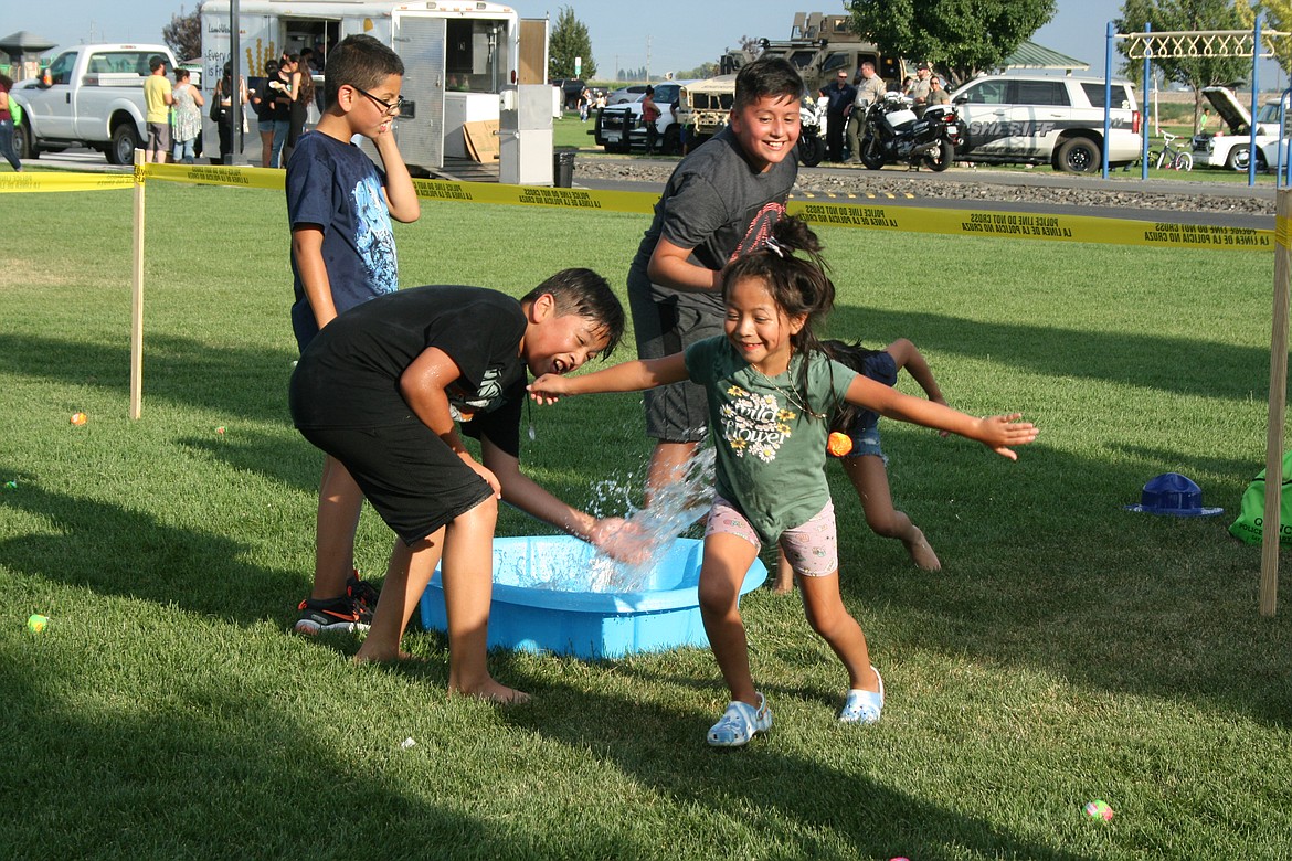 Children play one of the games that were part of National NIght Out in Quincy Monday.
