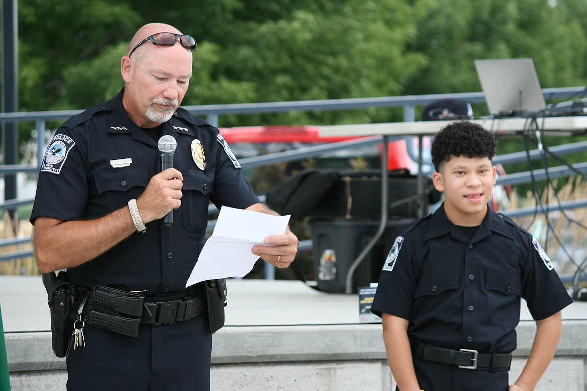 Quincy Police Chief Keith Siebert (left) introduces the Chief for a Day, Christopher James, during National Night Out Monday in Quincy.
