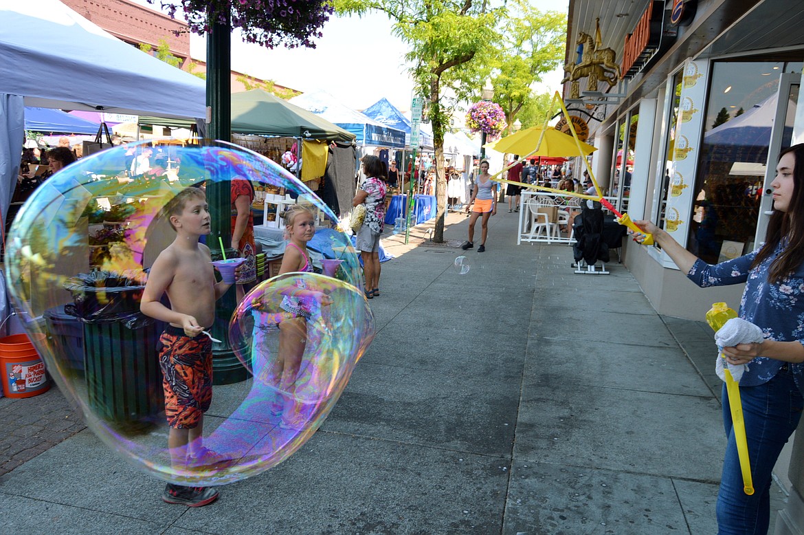 Kids enjoy bubbly fun during the Coeur d'Alene Downtown Association's Street Fair in 2018. This year's event will stretch along Sherman Avenue Friday through Sunday.