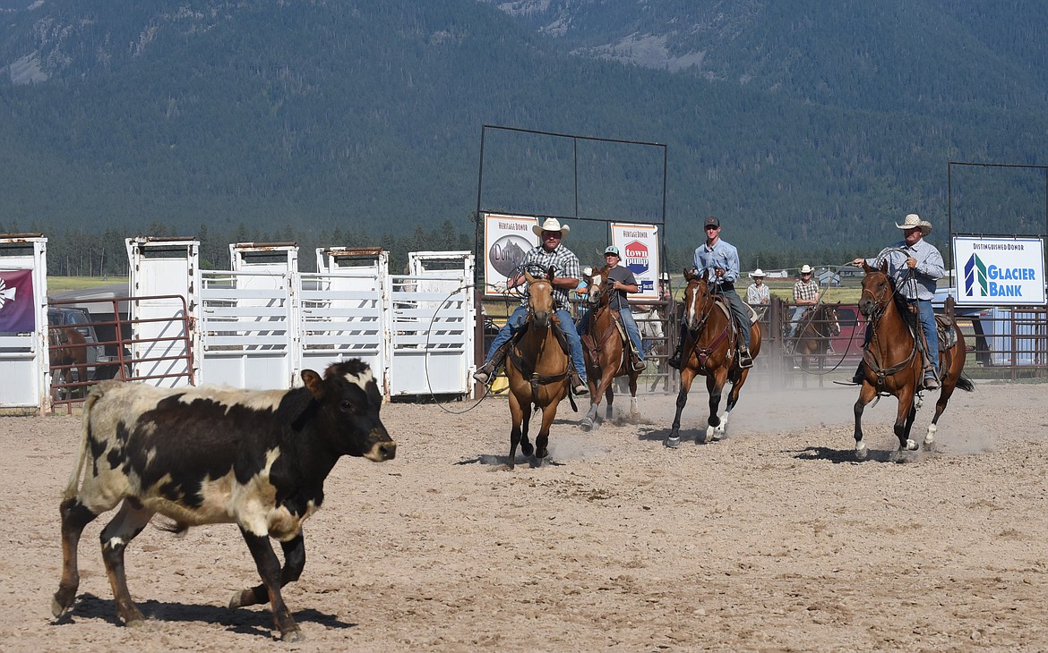 Paul Guenzler, Hallie Nelson, Tanner Berg, and Will Harris chase down a steer in the combined event during the Ranch Rodeo. (Marla Hall/Lake County Leader)