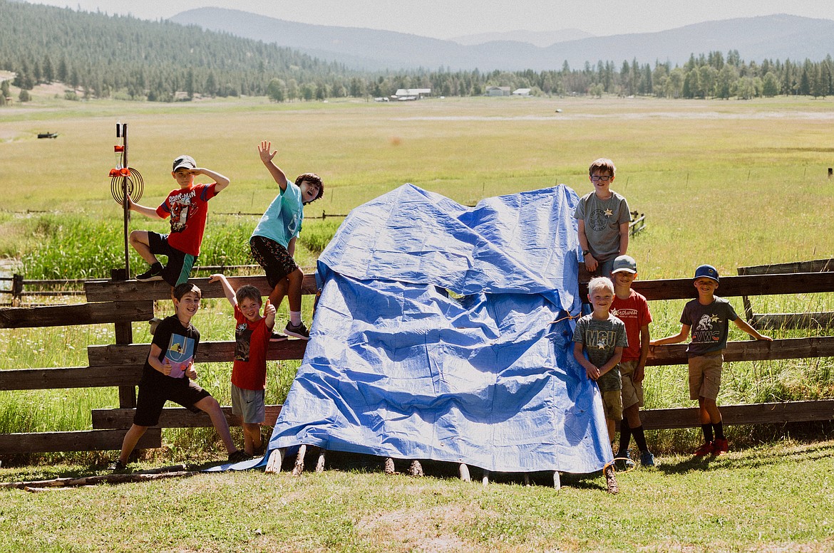 Students from St. Matthew’s Catholic School constructed a shelter during the school’s Adventure Camp last month. Students are, from left, Camden Ottosen, Boston Jackson, Emmett Jackson, Zeke Christianson, Carson Hunter, Owen Lybeck, Thomas Lybeck, and Matthew Lybeck. (Courtesy photo)