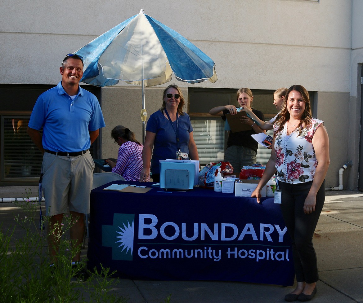 Bonners Ferry High School Athletic Director Nathan Williams (left), Administrator to the BFHS Athletic Department Anne Tompkins (center) and Danielle Larsson (right), community relations and marketing director at Boundary Community Hospital help athletes and parents sign up for physicals at Free Physical Day at BCH.