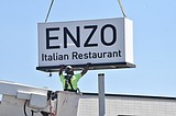 Enzo installs sign