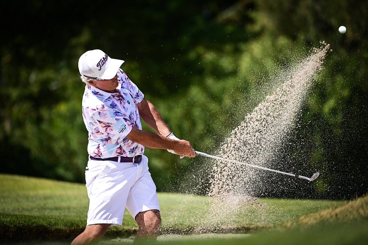 Brad Grattan chips out of a greenside bunker on the 11th hole during the Montana State Senior Golf Tournament at Buffalo Hill Golf Club on Thursday, Aug. 4. (Casey Kreider/Daily Inter Lake)