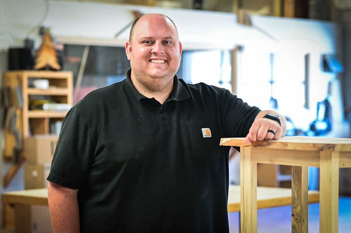 Career and Technical Education teacher Ben Butts with one of the side tables his students make during an entry-level woodworking class at Flathead High School on Thursday, Aug. 4. (Casey Kreider/Daily Inter Lake)