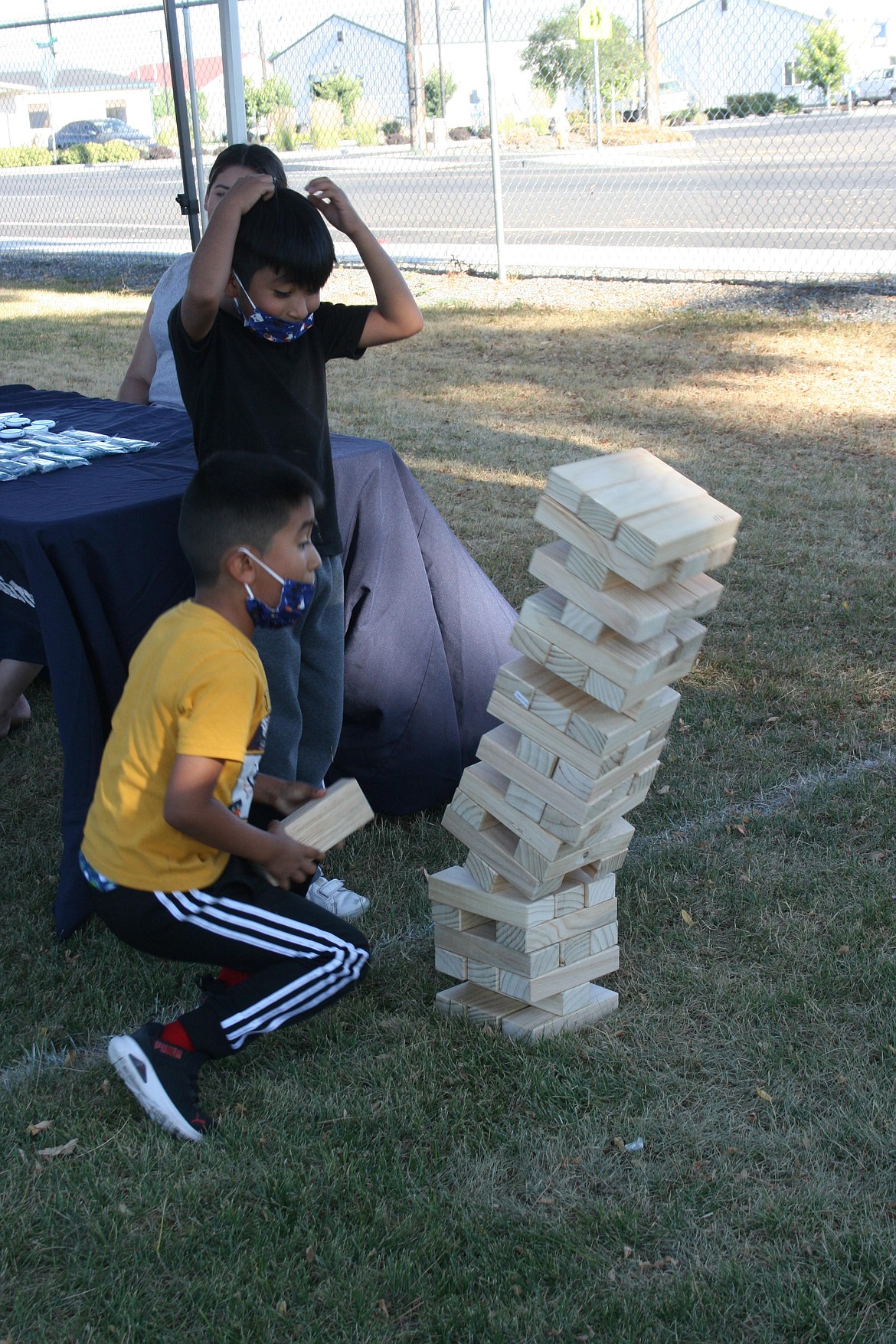 The tower goes down, to the chagrin of the children playing, during National Night Out in Mattawa.