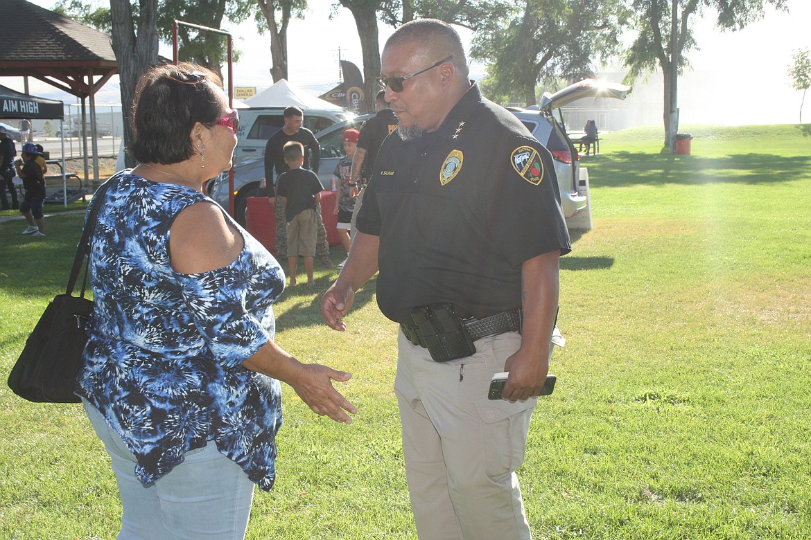 Mattawa Police Chief Robert Salinas (right) talks to a Mattawa resident during National Night Out.