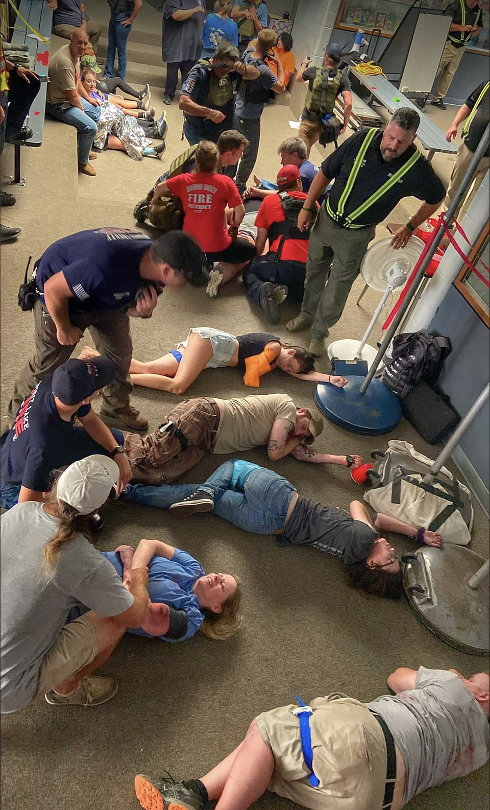 Silverback instructor Michael Wisner (center right in reflective vest) oversees local EMS crews treating 'patients' in the casualty collection point during Wednesday's school shooting drill.