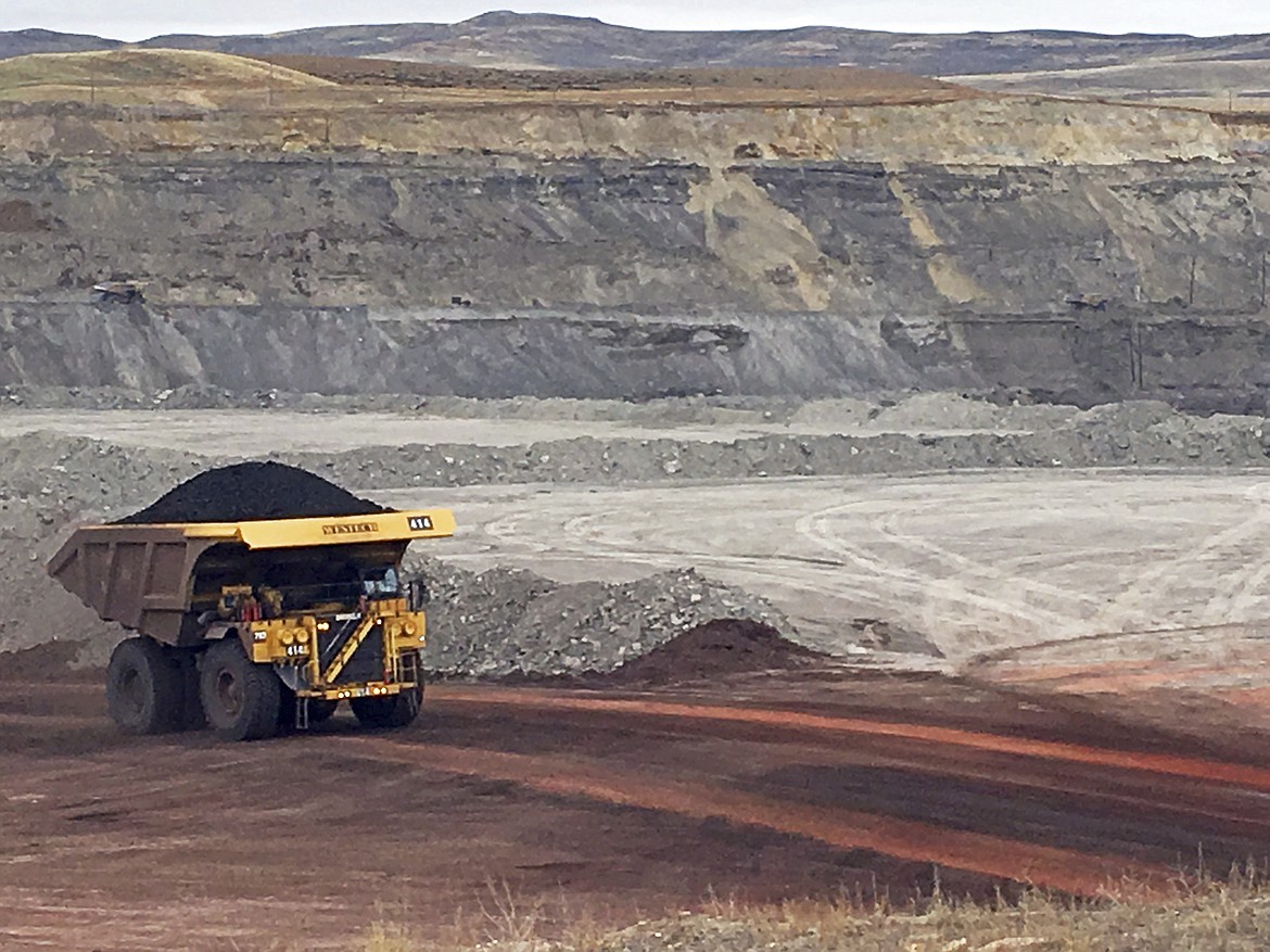 FILE - In this March 28, 2017 file photo, a dump truck hauls coal at Contura Energy's Eagle Butte Mine near Gillette, Wyo. A judge has ruled U.S. government officials engaged in regional-level planning failed to follow a court order requiring them to consider allowing less coal to be mined as a way to fight climate change. The Wednesday, Aug. 3, 2022 ruling by U.S. District Judge Brian Morris in Great Falls, Montana, applies to the country’s top coal-producing region, the Powder River Basin of Wyoming and Montana. (AP Photo/Mead Gruver, File)