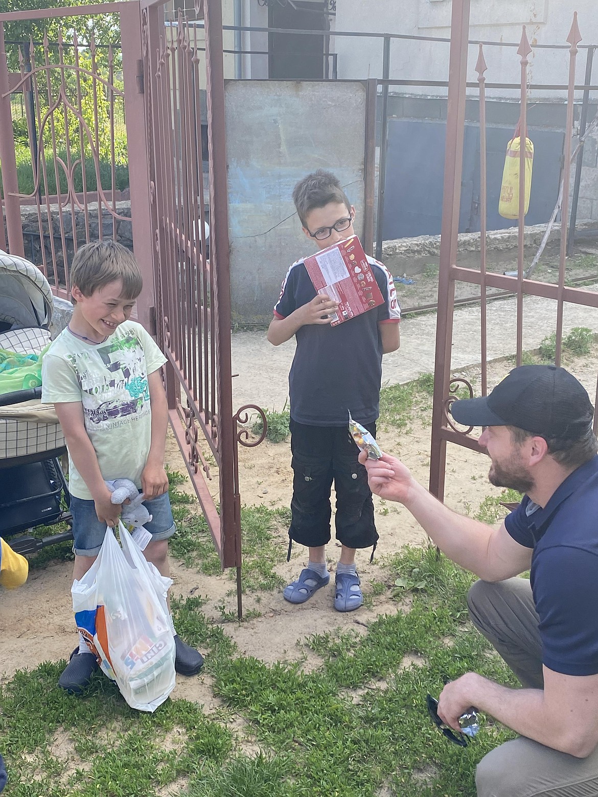 Jared Malone, a Heritage Health counselor, offers candy to a child in Ukraine.