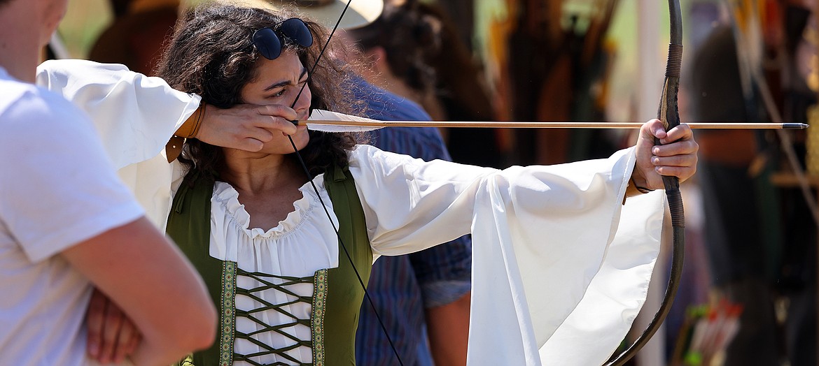 A patron tests her skills with a bow and arrow at the Montana Renaissance Faire on the grounds of the Majestic Valley Arena Saturday, July 30. (Jeremy Weber/Daily Inter Lake)