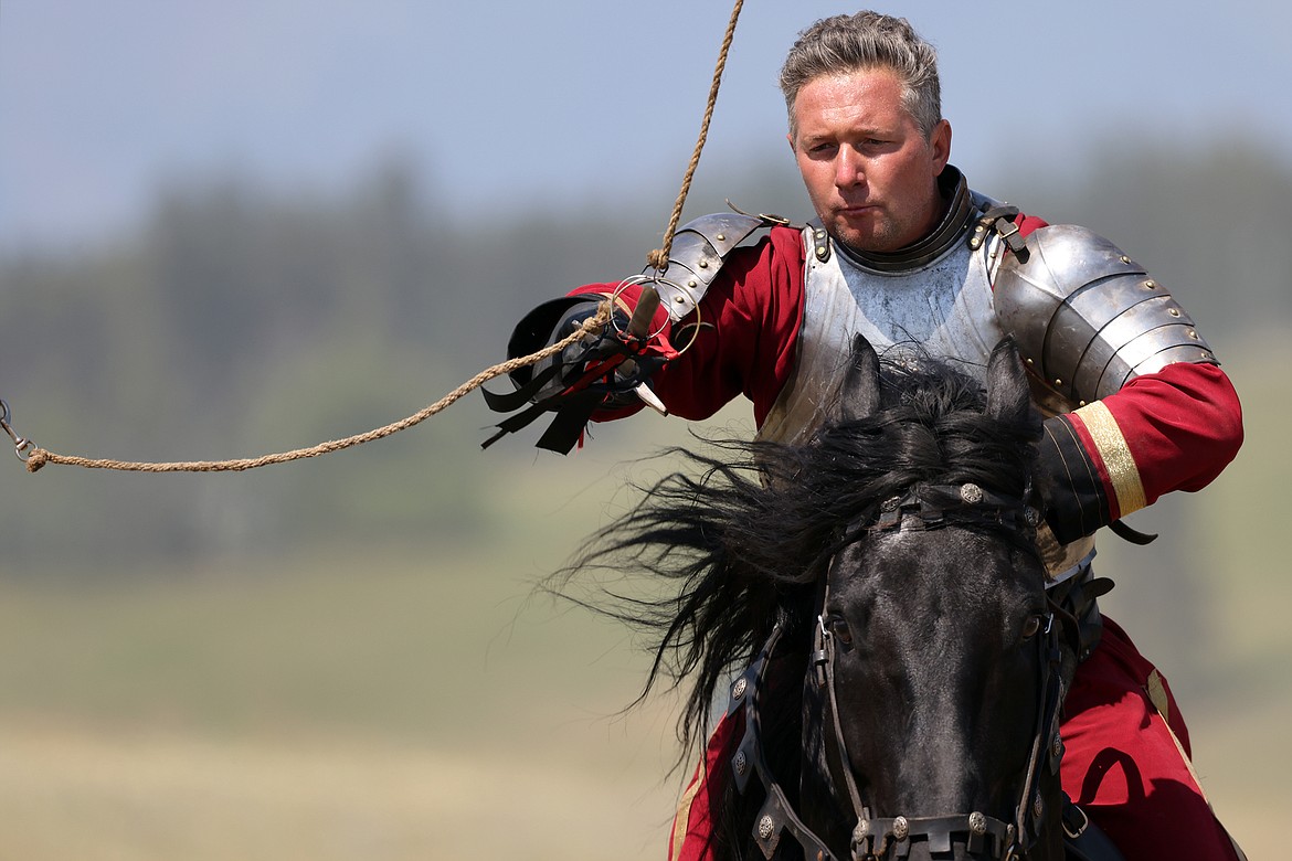 A knight uses his sword to capture a ring at full gallop at the Montana Renaissance Faire on the grounds of the Majestic Valley Arena Saturday, July 30. (Jeremy Weber/Daily Inter Lake)