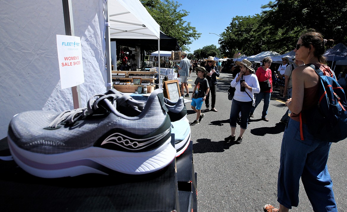 Shoes attract the attention of passersby at Fleet Feet during the Street Fair on Friday.