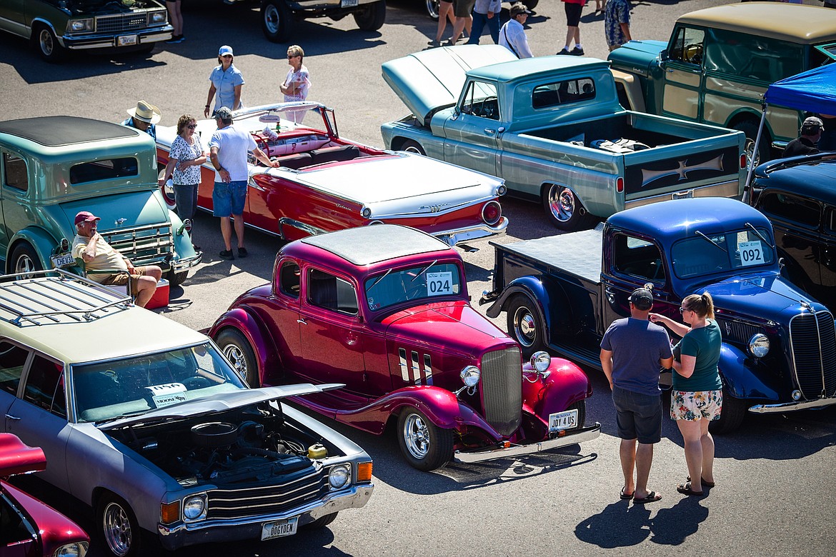 Attendees walk through rows of classic vehicles at the Evergreen Show 'N Shine car show at Conlin's Furniture on Saturday, Aug. 6. (Casey Kreider/Daily Inter Lake)