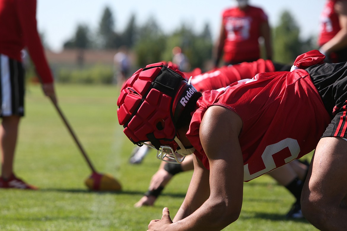 The defensive line awaits the snap in a drill meant to keep them from jumping offsides.