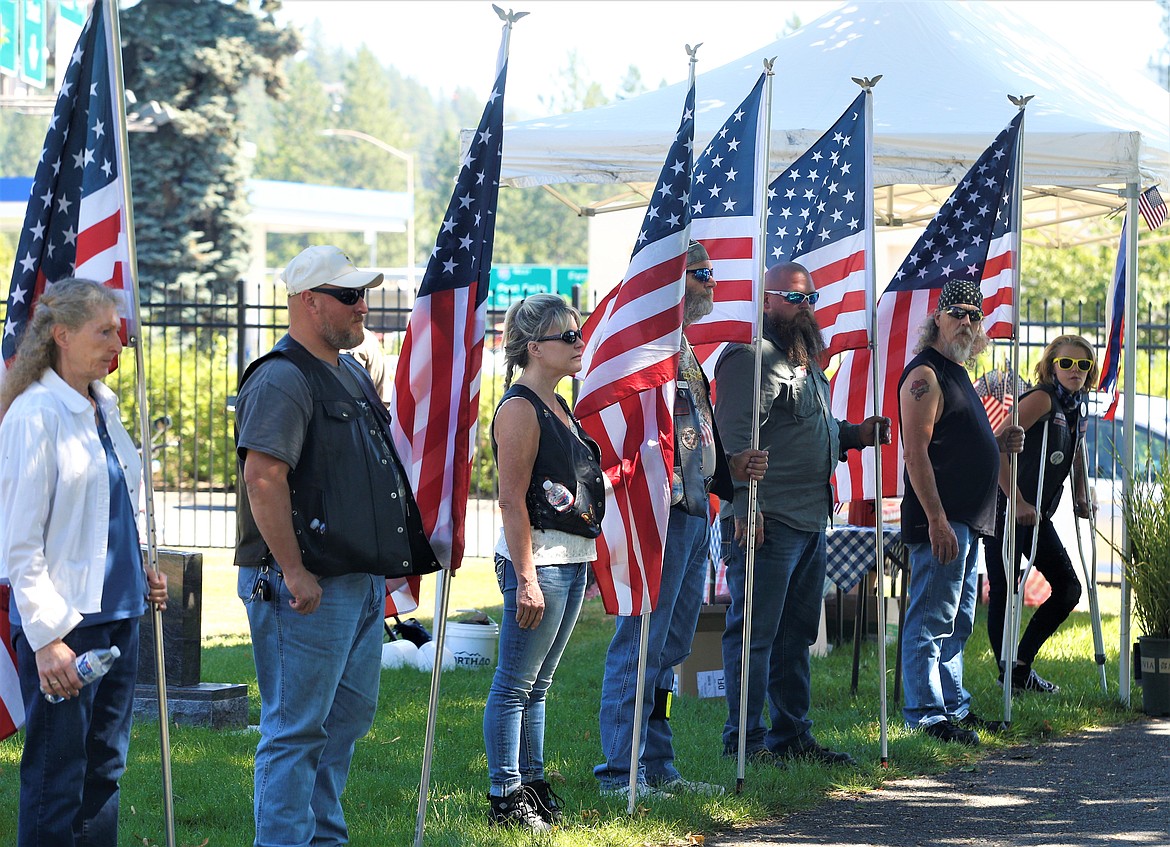 Members of the Panhandle Patriot Riders hold flags during Sunday's veterans monument dedication.