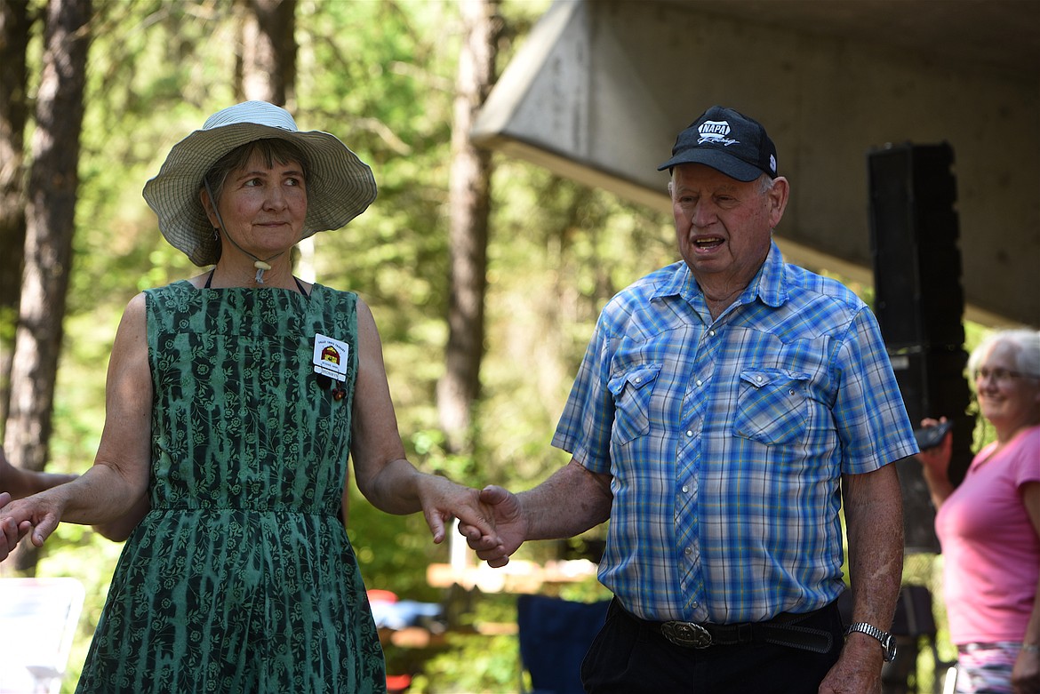 Bronwyn Brady, left, and Don Burrell share a dance at the Libby Spinning Squares Libby Dam Dance Sunday, Aug. 7. (Scott Shindledecker/The Western News)