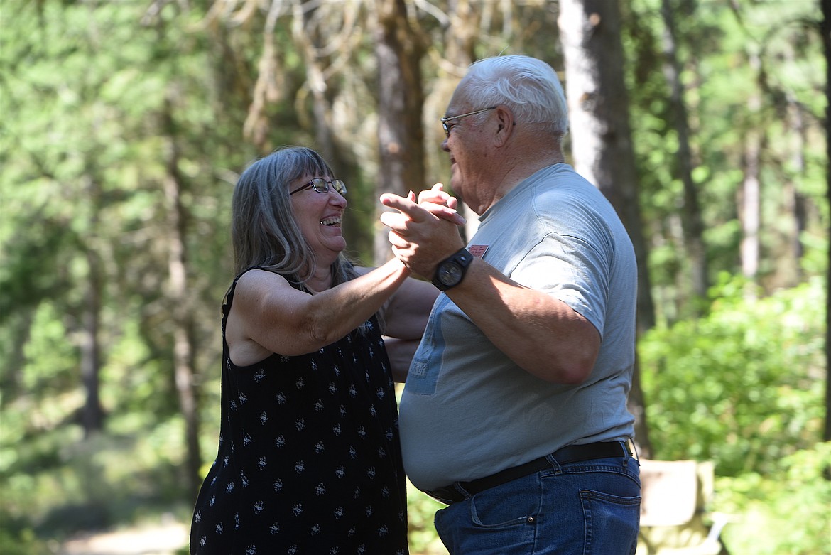 Rhonda Taigaffi, left, and Dennis Jones share a laugh during the Libby Spinning Squares Libby Dam Dance Sunday, Aug. 7. (Scott Shindledecker/The Western News)