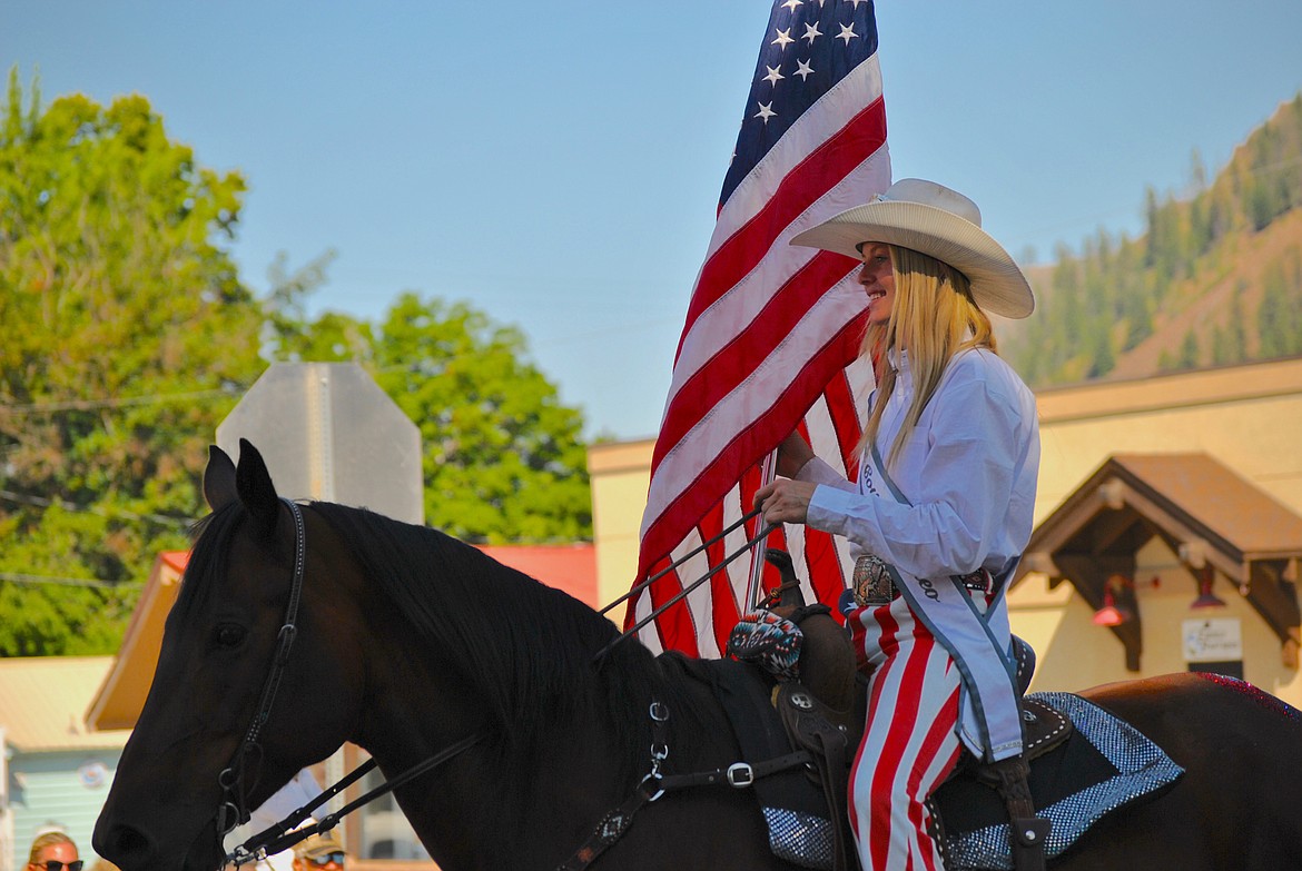 Heather Haskins leads Old Glory along the parade route Saturday morning in Superior for the Mineral County Fair. (Mineral Independent/Amy Quinlivan)
