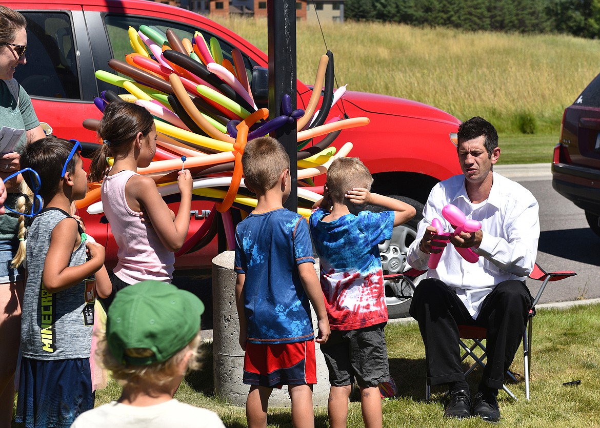 Magician and balloon artist Drew Miller made animals of all colors while some kids were prepared for possible popping balloons at the Kids Fair. (Julie Engler/Whitefish Pilot)
