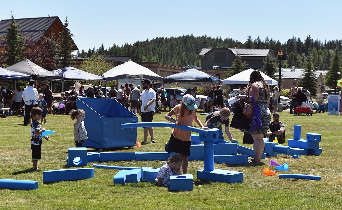 Families play with large blocks at the Kids Fair on Aug. 3. The event was hosted by the Flathead Valley Breastfeeding Coalition. (Julie Engler/Whitefish Pilot)