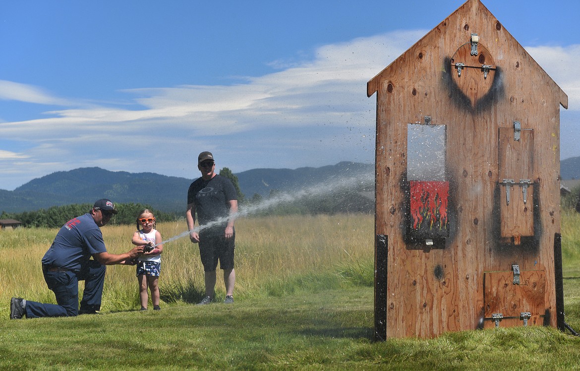 The Whitefish Fire Department was on hand to help kids knock out pretend fires with a firehose during the Kids Fair on Aug. 3. (Julie Engler/Whitefish Pilot)