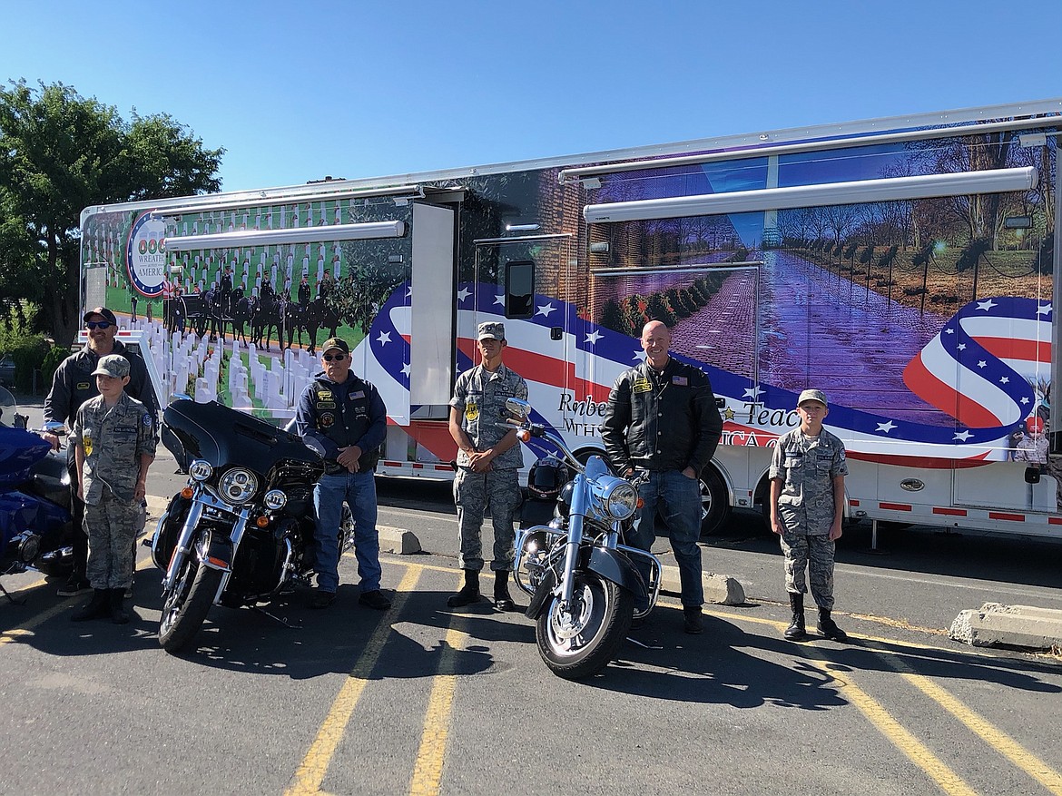 Combat Motorcycle Veterans who stopped by the mobile exhibit pose with Civil Air Patrol cadets in front of the trailer.