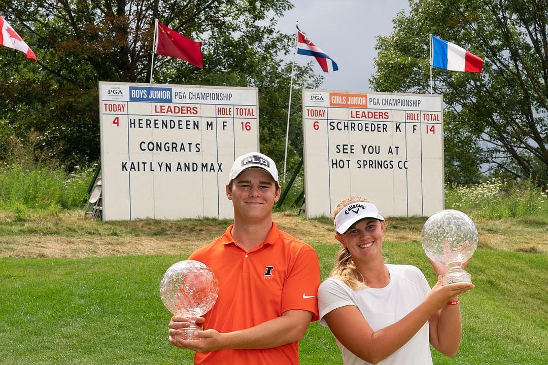 Junior PGA Championships winners Max Herendeen and Kaitlyn Schroeder stand with their trophies after their wins.