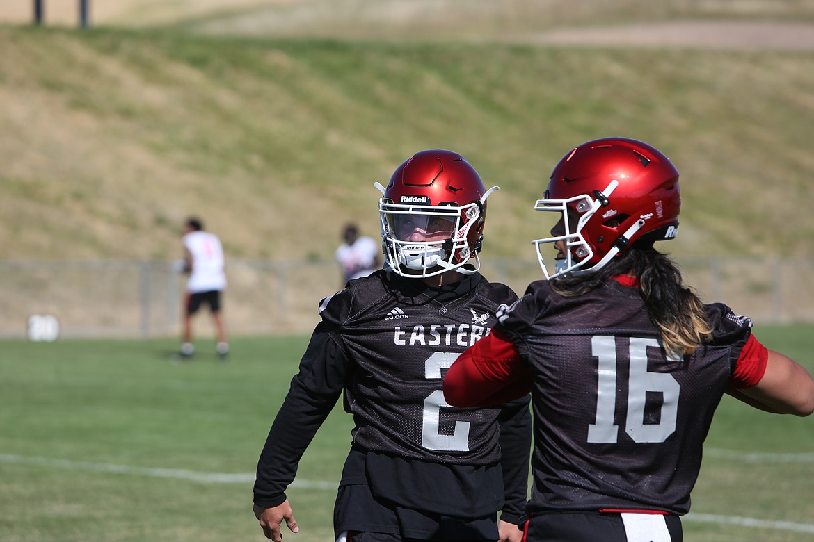 EWU quarterbacks Gunner Talkington (left) and Kekoa Visperas (right) take turns in drills.