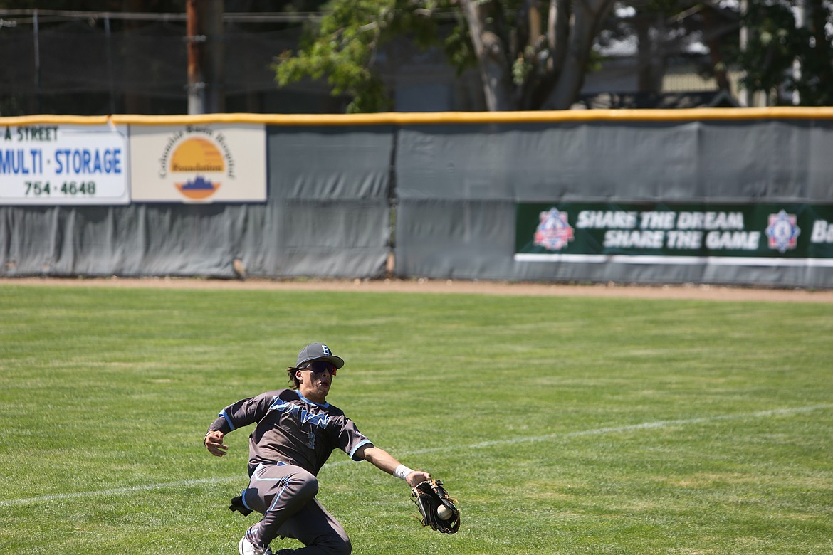 Northwest Bakersfield outfielder Andres Rivera lays out for a ball going into foul territory.